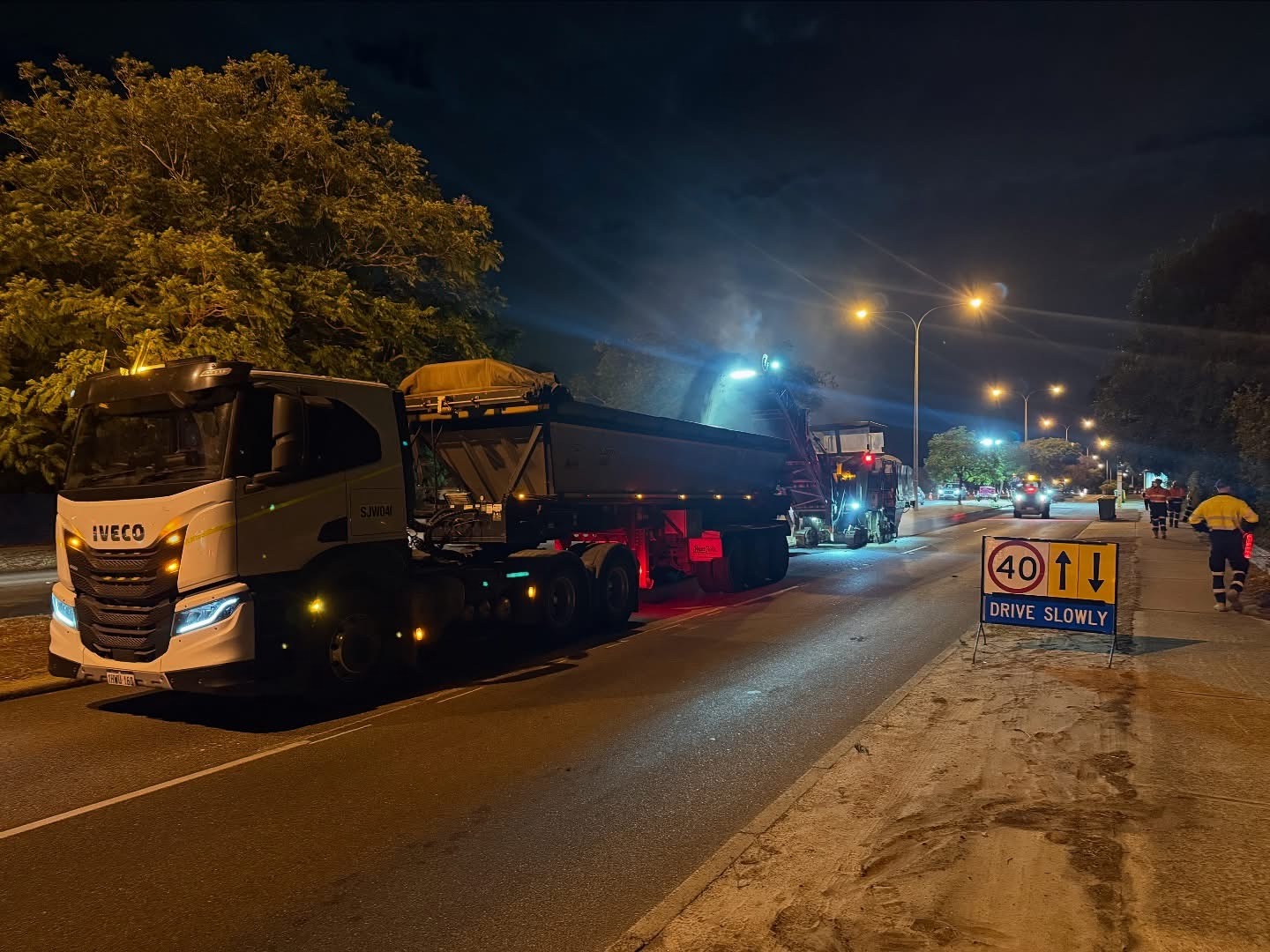 YongaCivil night profiling operation with cold milling machine and tipper truck on a Western Australian road